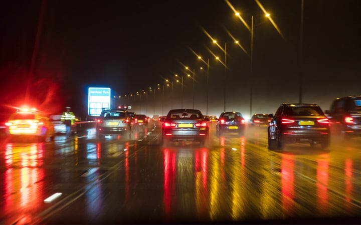 Motion blurred photograph of traffic at in night in the rain on a British motorway