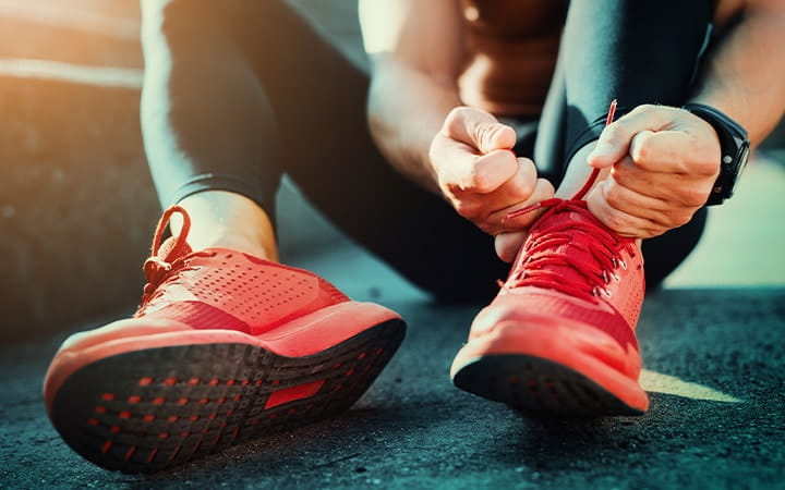 Young man tying sports shoes before workout