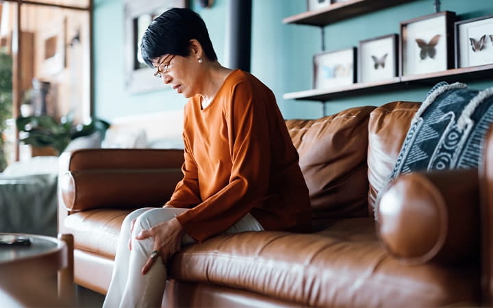 Woman massaging her painful legs