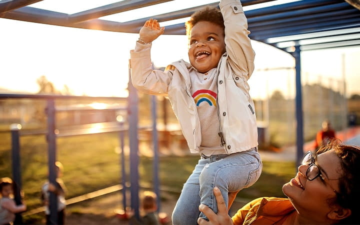 A child playing with his mother in a public park