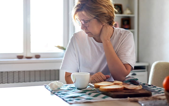 Older woman looking away from her breakfast