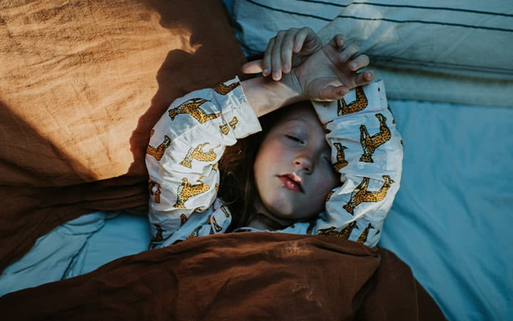 child sleeping in bed