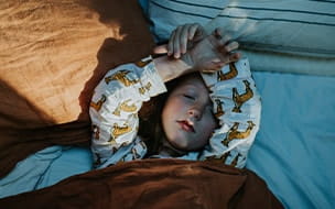 child sleeping in bed