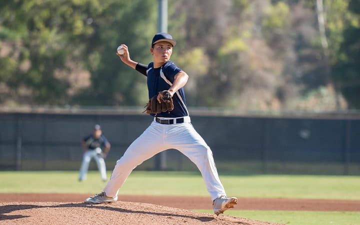 Youth baseball pitcher throws ball