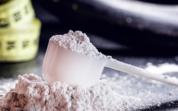 A scoopful of creatine, hmb, bcaa, amino acid or powdered vitamin
