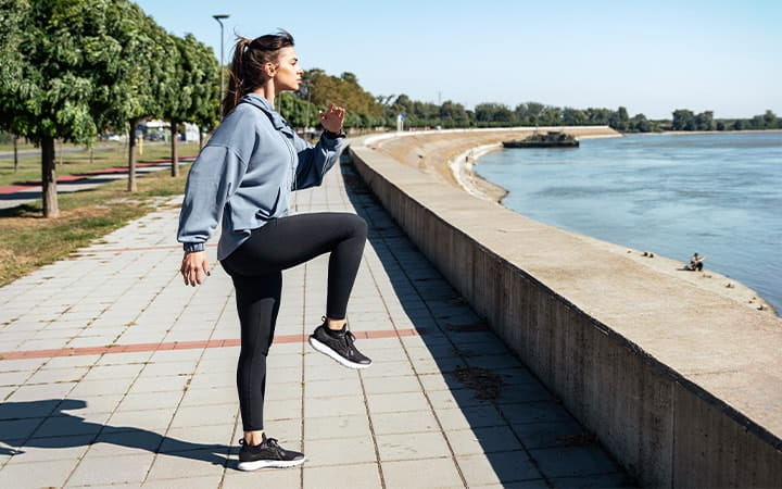 Woman Practices Dynamic Stretching