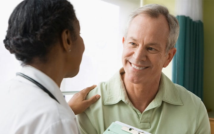 Mature man talking to doctor