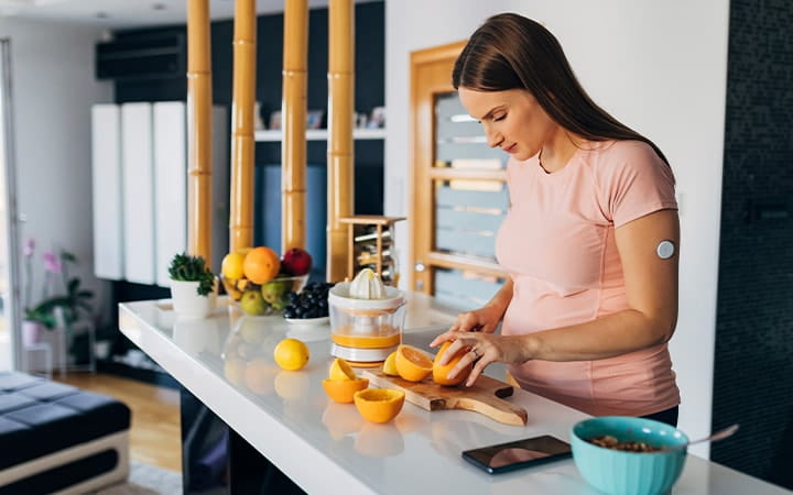 Pregnant woman cuts fruit