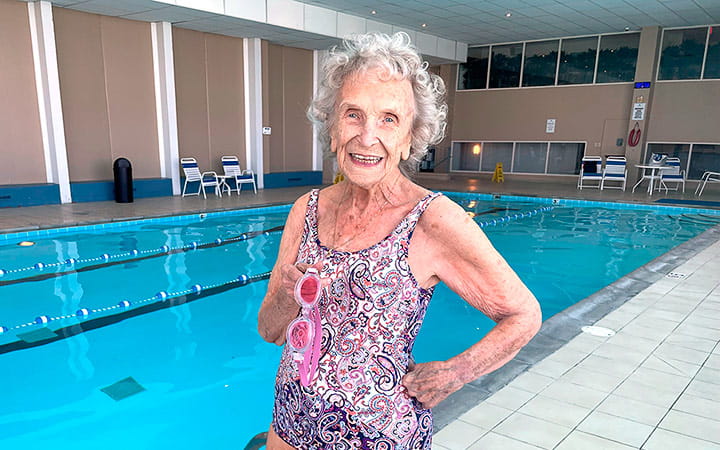 Fay Porter stands beside an indoor swimming pool