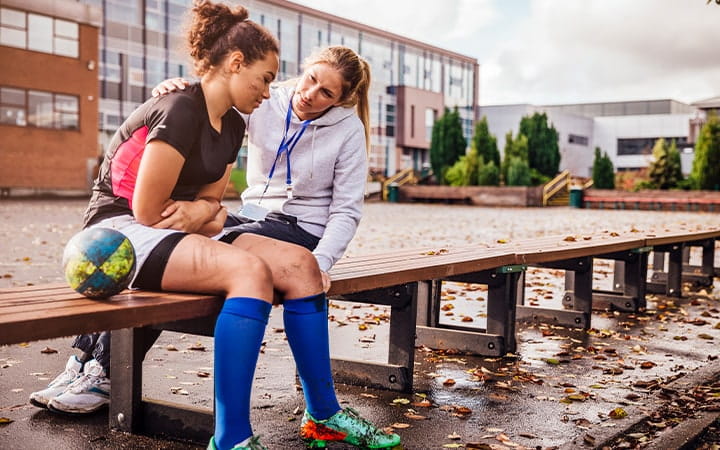 Coach talks to young rugby player