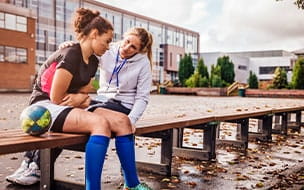 Coach talks to young rugby player