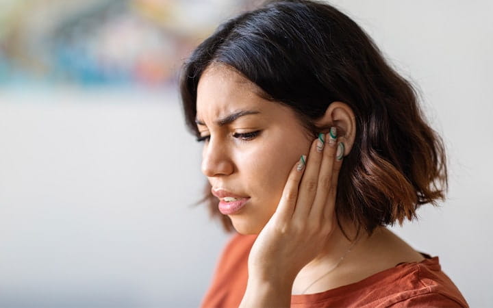 A young woman suffering from earache