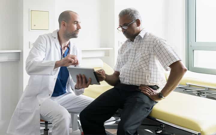 Older man talking to doctor