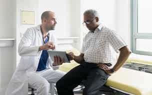 Older man talking to doctor