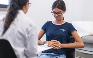 child with stomach pain visits doctor