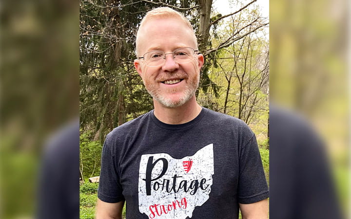 Korey Loughry smiles outdoors