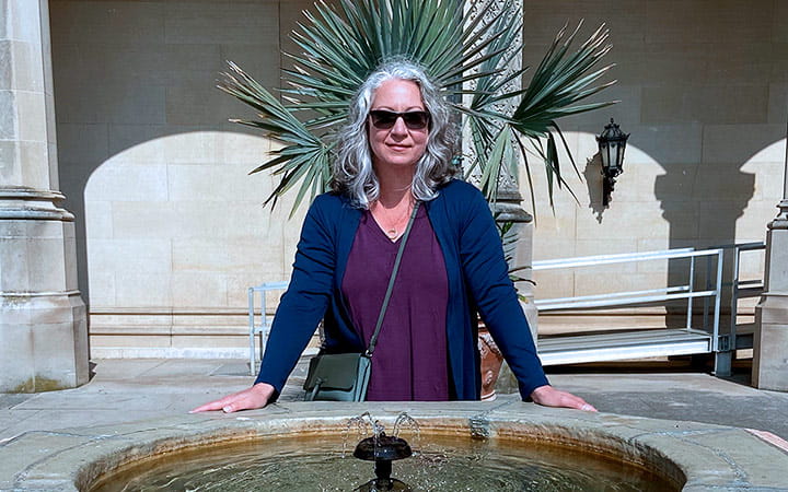 Aletah Whitman outdoors by a fountain