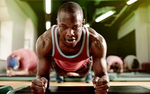 A man doing a plank exercise at the gym