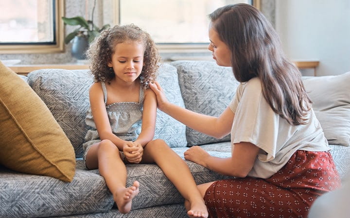 Mom consoles young daughter