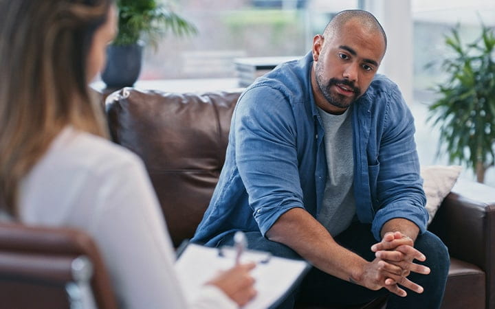 Young man talking to therapist