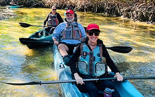 Debra with her husband and daughter, Lauren, who is a physical therapist at UH