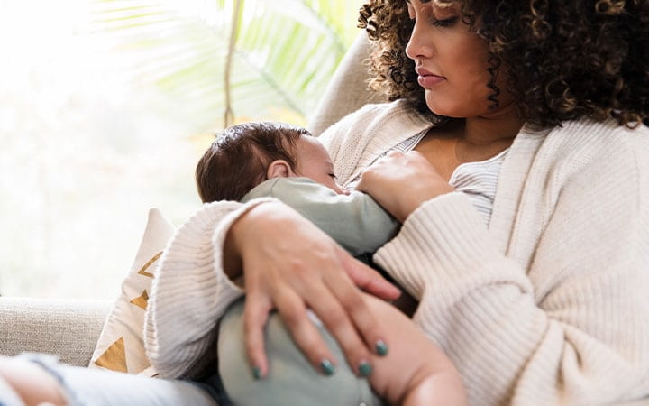 mother breastfeeds infant