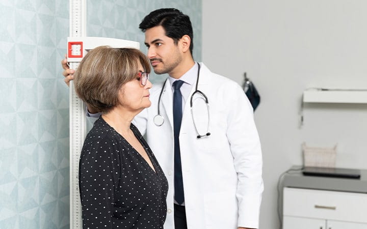 Doctor Measures a Woman's Height