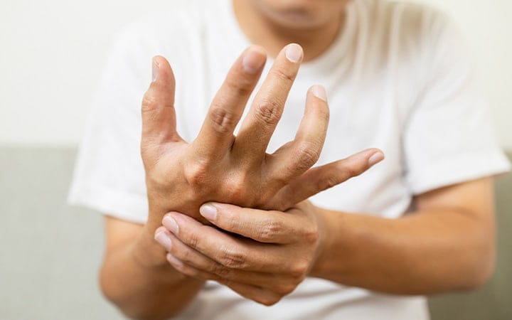 Man massages hand