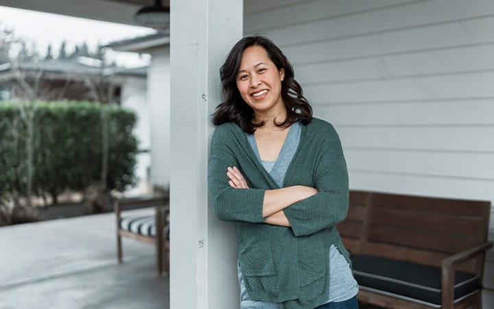 Smile woman stands on porch