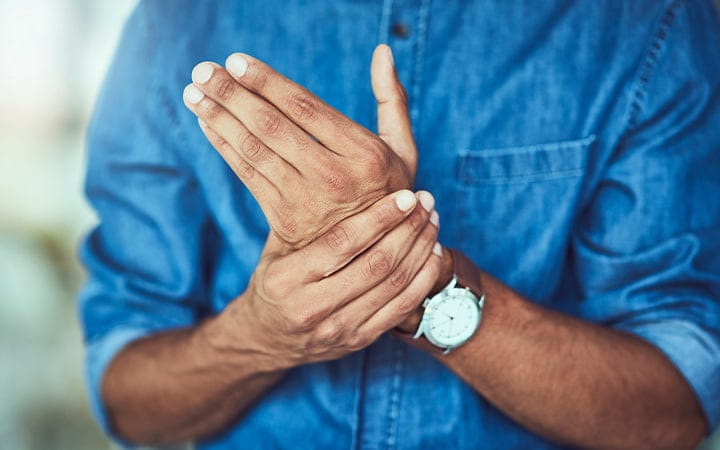 A man massages his hand