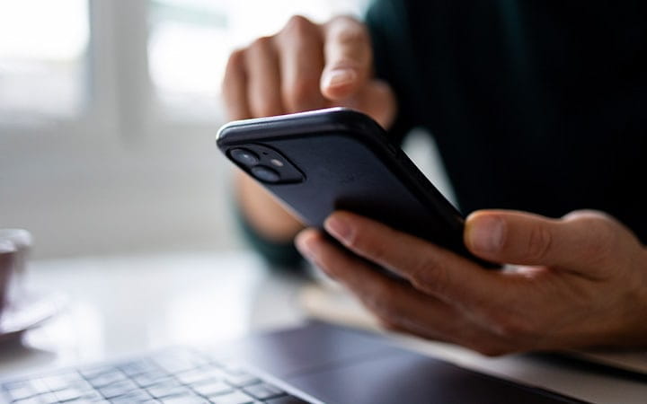 Person tapping a mobile phone