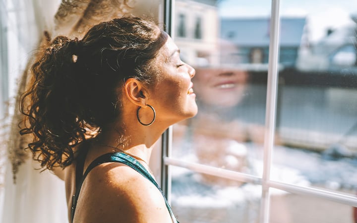 A woman enjoying the sunshine during the break between exercises