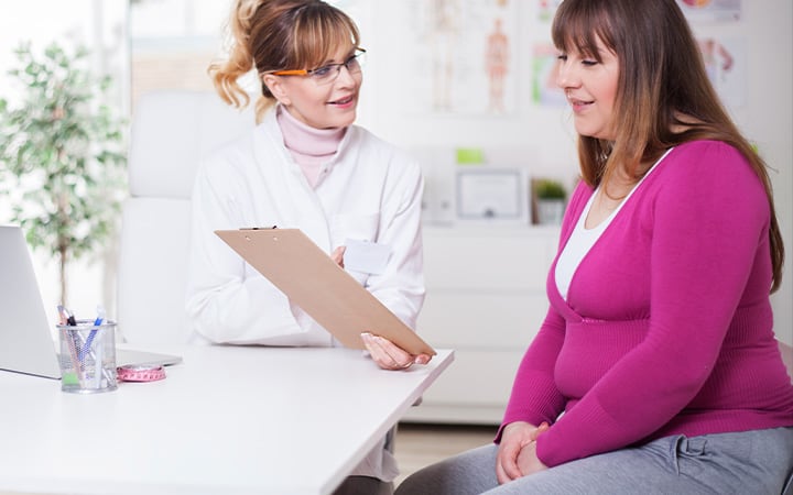 Female doctor talking to overweight woman