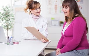 Female doctor talking to overweight woman
