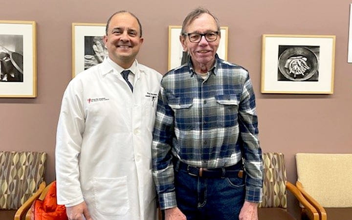 Rod Rezaee, MD stands with patient Joe Bidinger