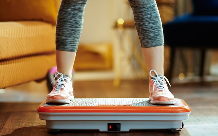 Woman standing on vibration platform