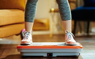 Woman standing on vibration platform