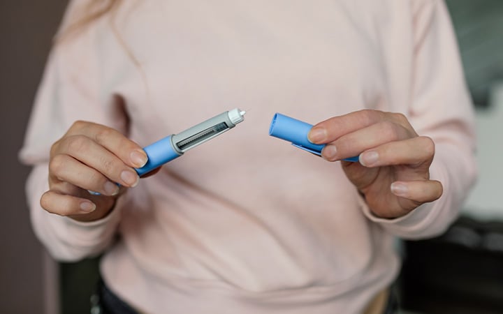 Woman holding injectable medication
