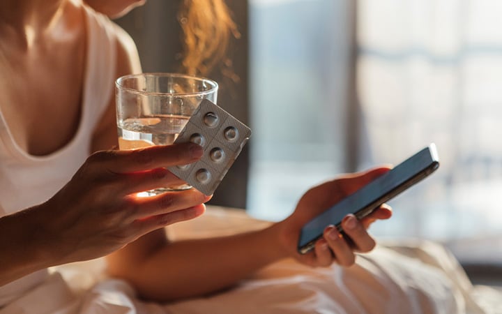 A young woman checking a prescription with smart phone