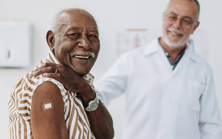 Smiling senior with bandage on shoulder