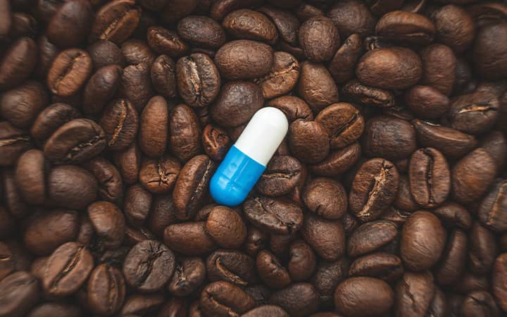 coffee beans and a pill