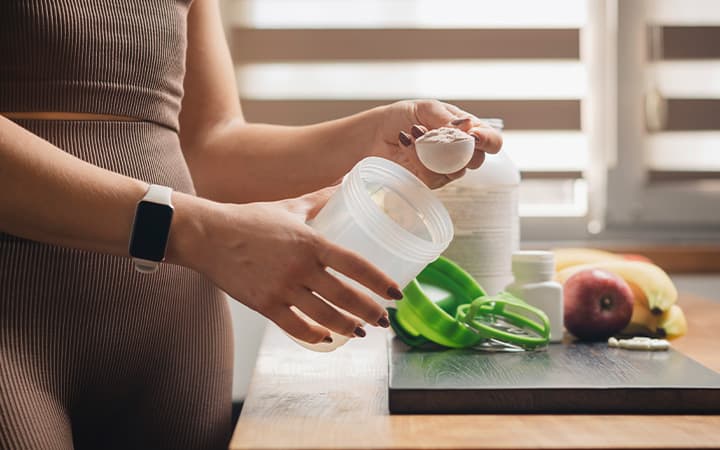 Woman measuring creatine powder