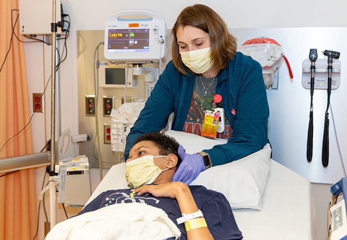 Mandy Bartolovich, Pediatric massage therapist with patient
