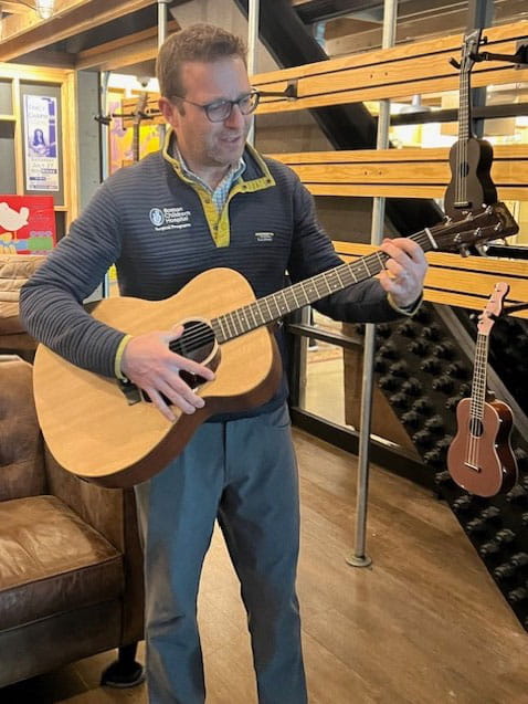 Benjamin Shore, MD Visiting Professor in orthopedics playing guitar at the Rock and Roll Hall of Fame during visit