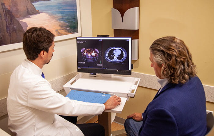 Dr. Pedro Barata viewing PET scan with patient at UH Seidman Cancer Center. Photo taken by UH with patient model.