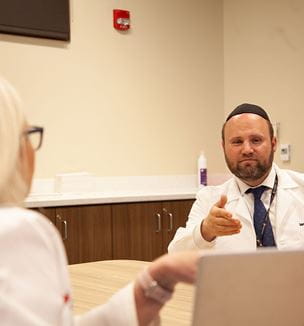Ian Neeland, MD UH Cardiovascular Medicine discussing in conference room