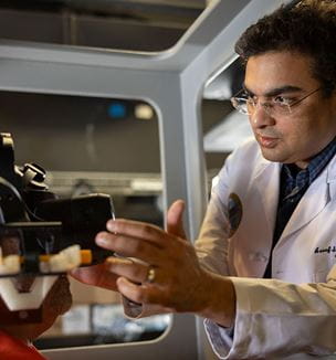 Aasef G. Shaikh, MD, PhD works with a research participant in the flight simulator at the Daroff Dell’Osso Lab.