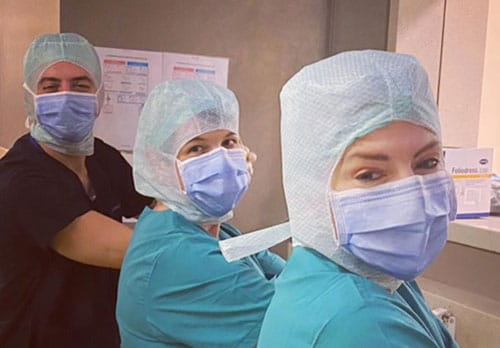 Dr. Meric Enercan of Istanbul, Turkey scrubs in for surgery beside Dr. Hardesty and Dr. Andras.