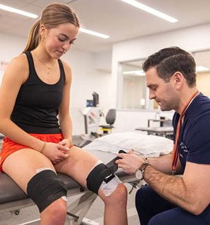 Physician placing wearable technology on patient.