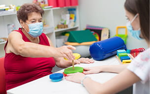 Senior woman doing physical therapy after suffering from stroke